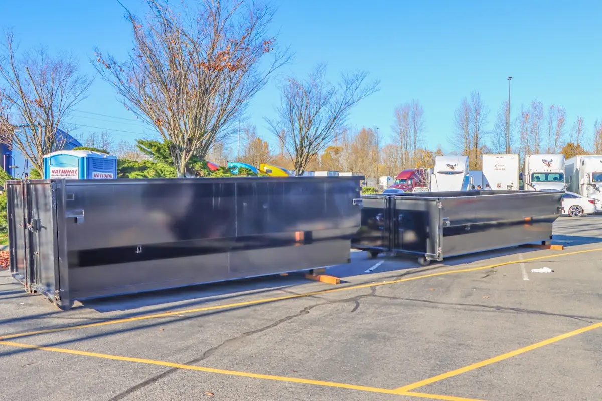 Professional dumpster rental service with roll-off container on residential driveway in San Lorenzo